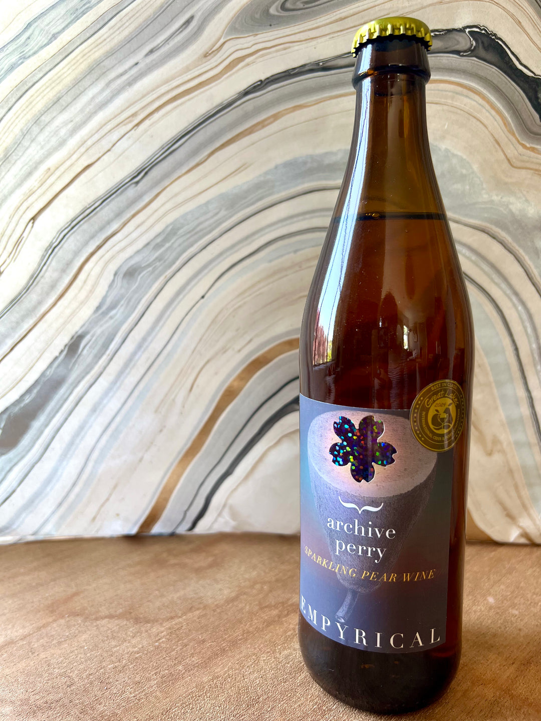 Picture of a bottle of cider with an award winning sticker, on a counter top