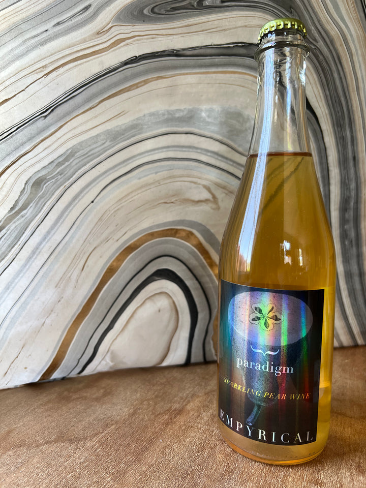 A picture of a bottle of cider on a counter top