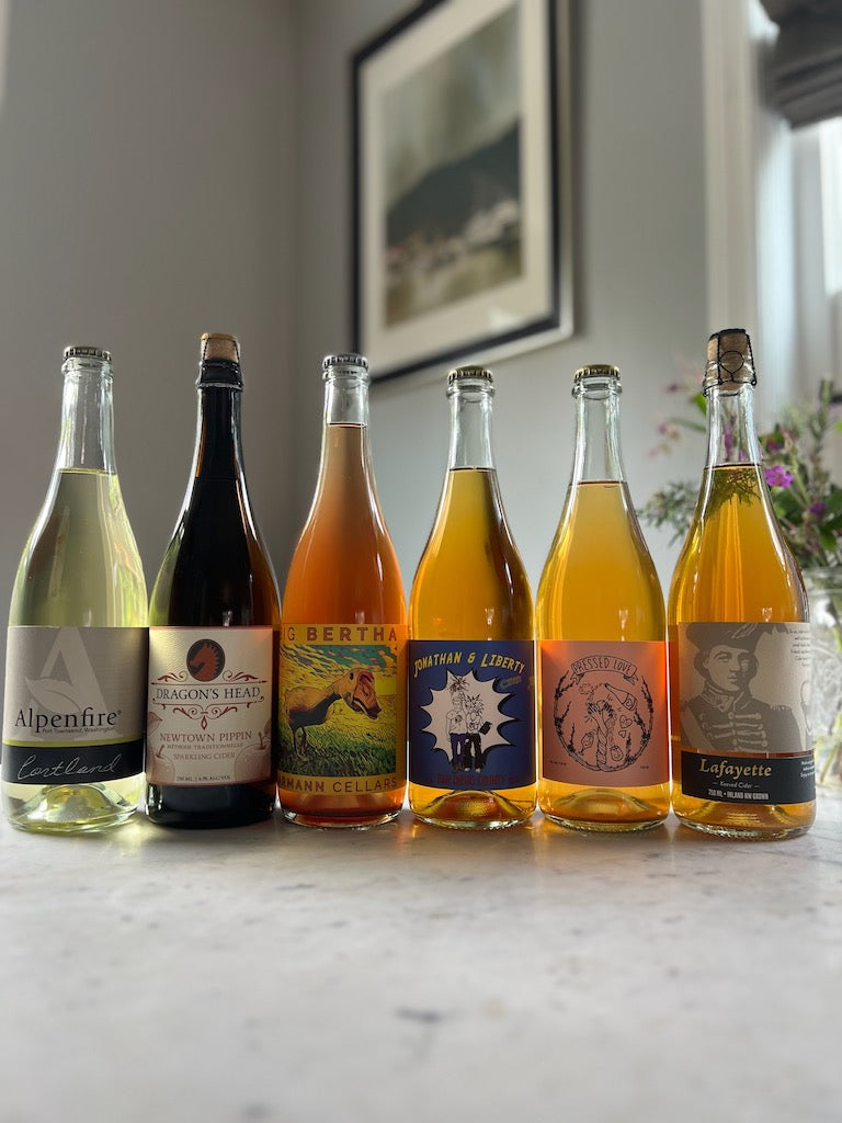 6 bottles of cider featured in a Cider Subscription Club box that highlights carbonation methods used in cider making