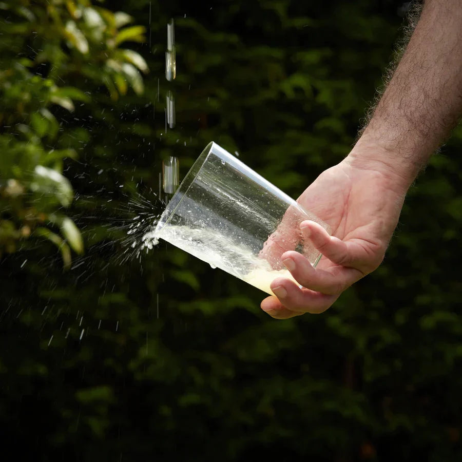 A glass of spanish cider being poured in the Long Pour method for Sidra
