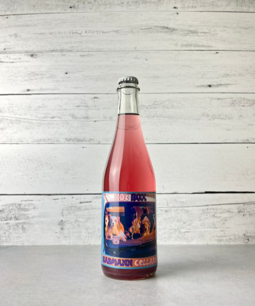 500 mL bottle of Barmann Cellars Hot Box Ciderkin in clear bottle with rose-pink colored cider grape cider