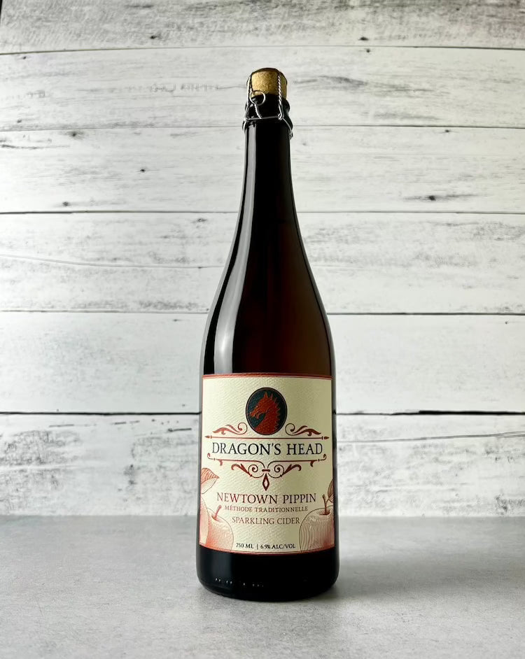 750 mL bottle of Dragon's Head Newtown Pippin Sparkling Cider with cork and cage top