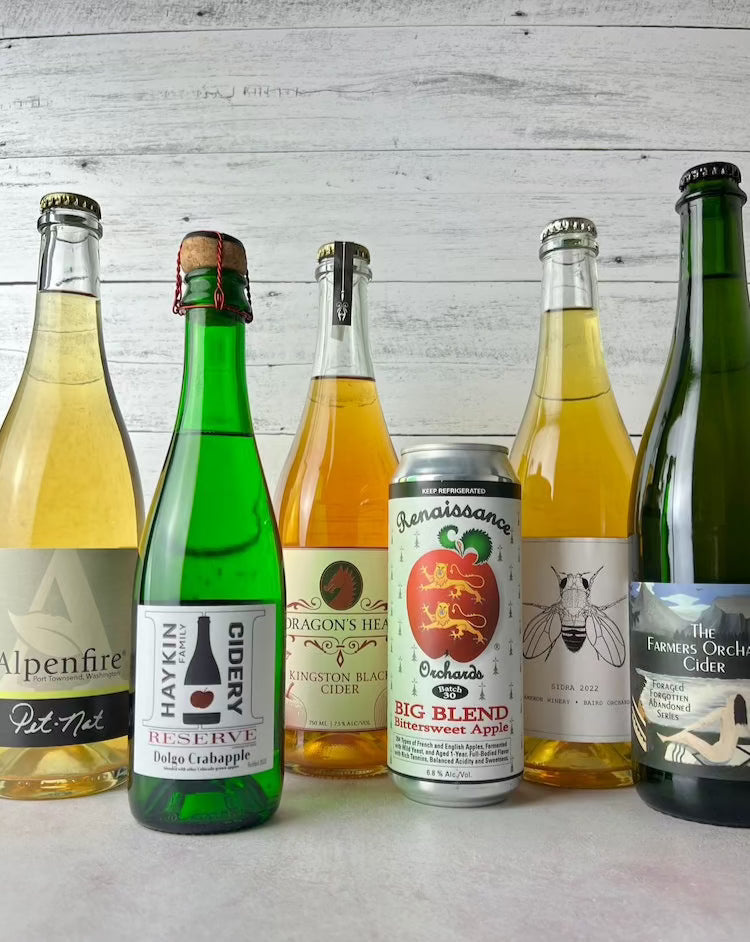 6 ciders, from left to right: Alpenfire Pet Nat, Haykin Dolgo Crabapple, Dragon's Head Kingston Black, Renaissance Big Blend, Cameron Winery Sidra, Botanist & Barrel The Farmer's Orchard
