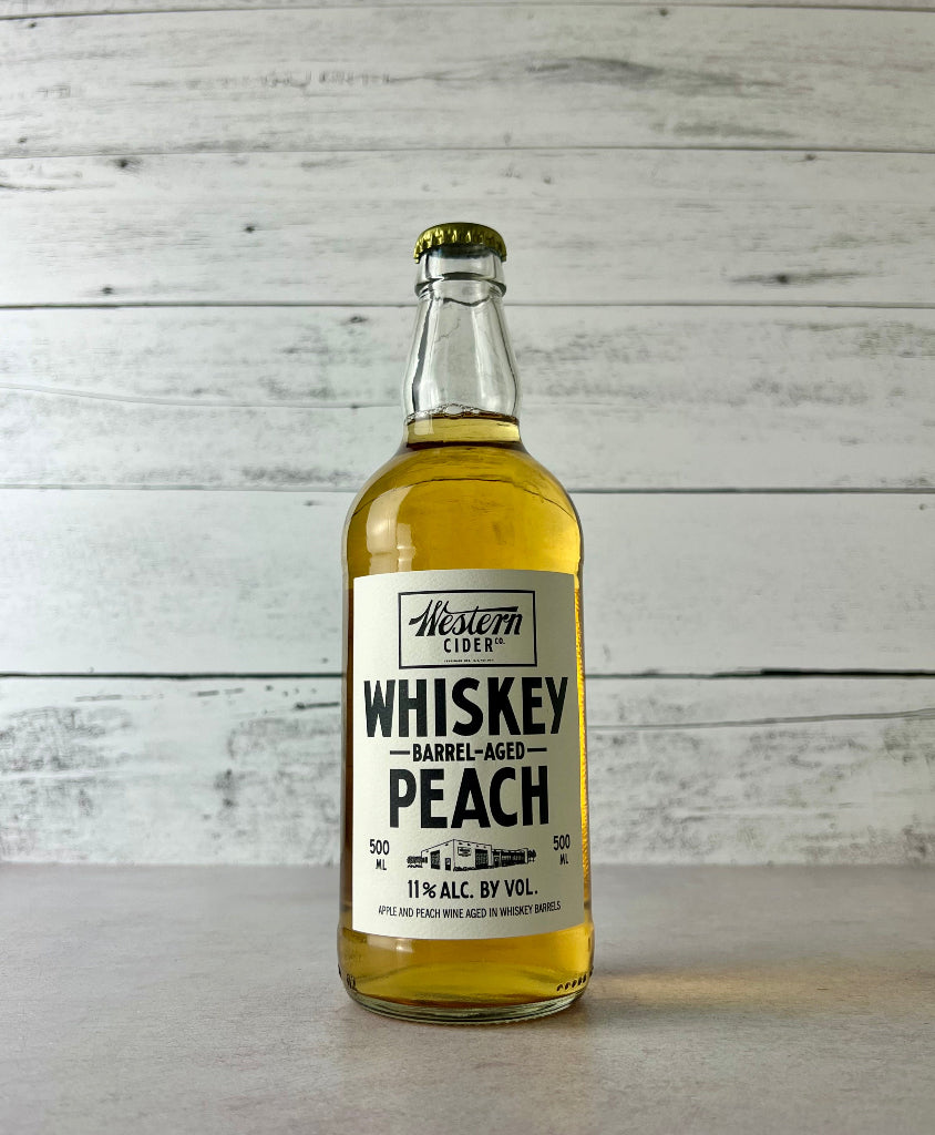 Photo of a 500 mL bottle of Western Cider Whiskey Barrel-Aged Peach cider