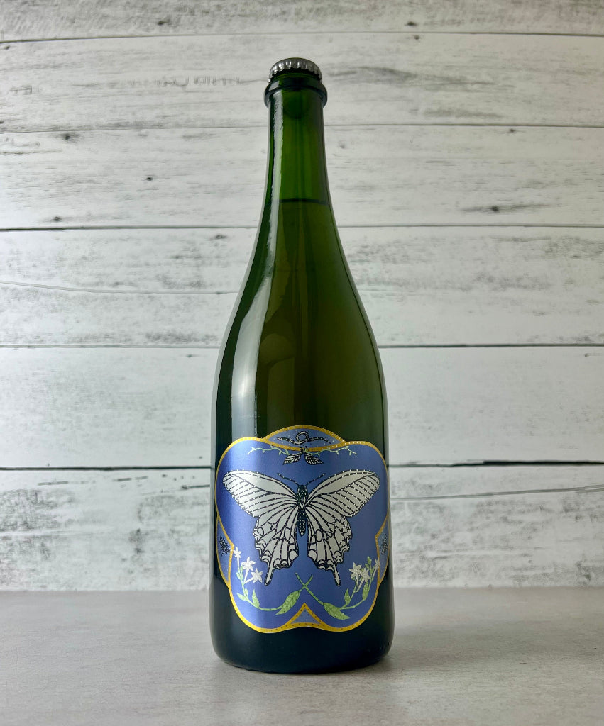 750 mL bottle of Art + Science Roshambo Cider with butterfly label