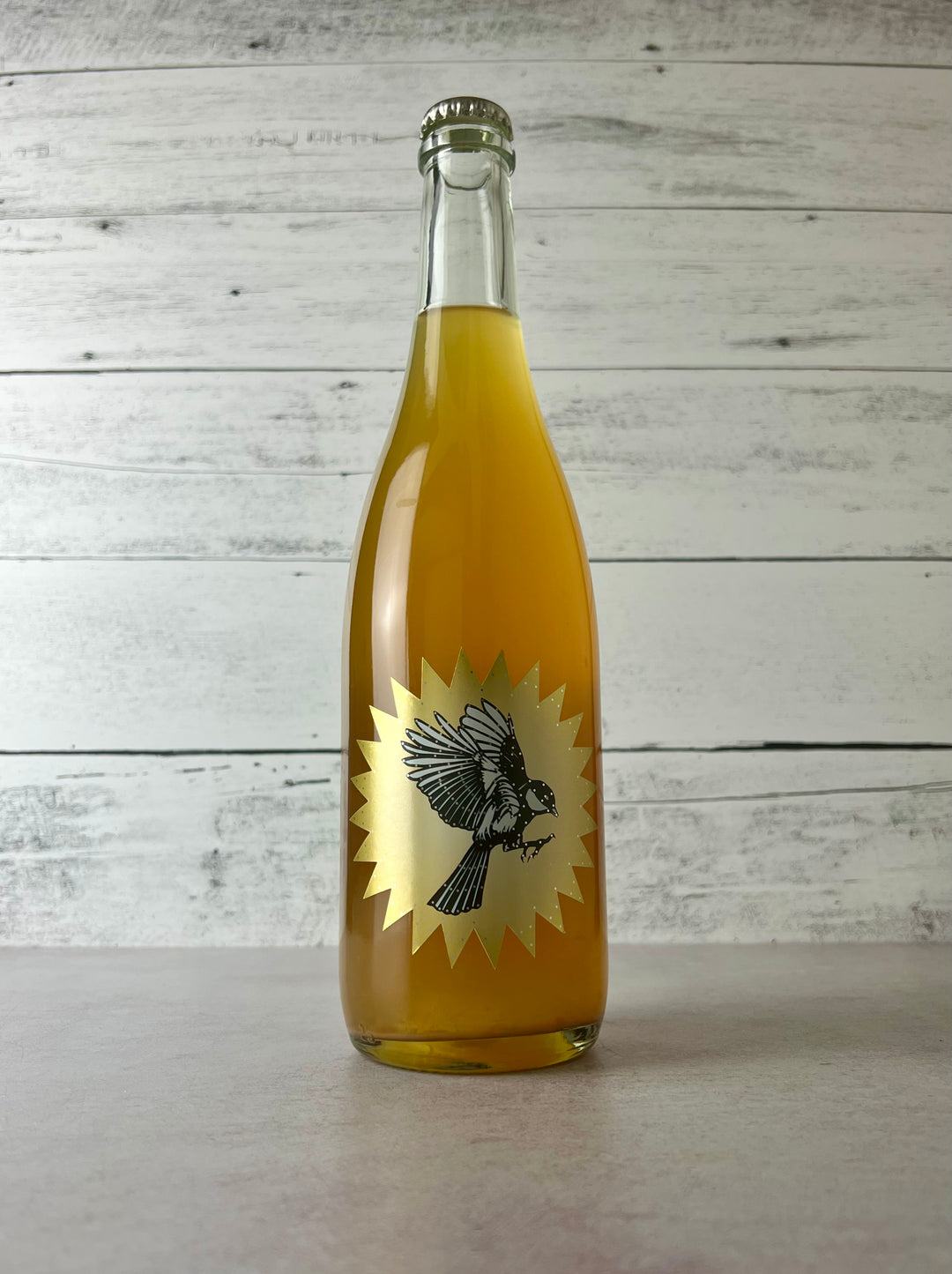 Photo of Art + Science Cider Quince in clear bottle with gold art label and bird