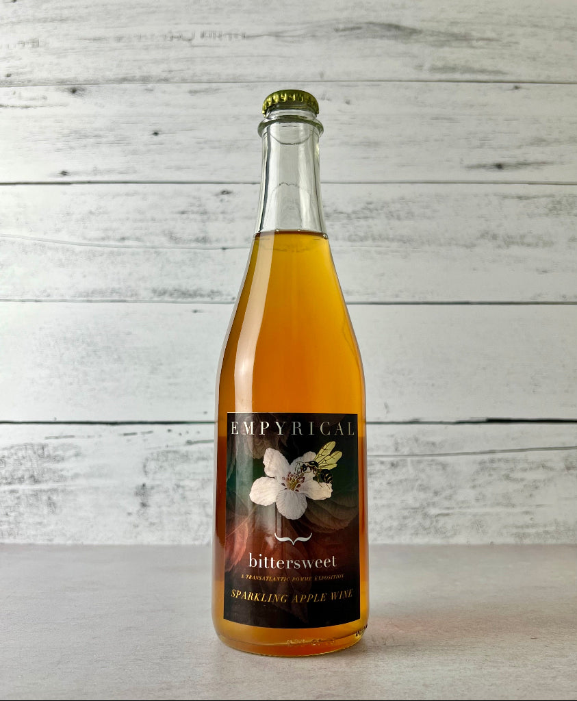 Photo of a 500 mL Bottle of Empyrical Cider Bittersweet sparkling apple wine on a wooden surface