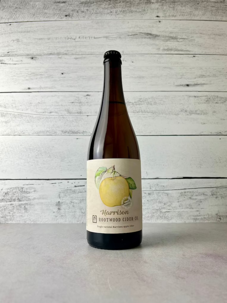 750 mL bottle of Rootwood Cider C. Harrison - Single varietal Harrison apple cider with artwork of a yellow Harrison apple