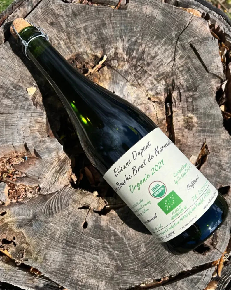 750 mL green glass bottle of Etienne Dupont Bouché Brut Organic Cider 2021 with cork and cage top