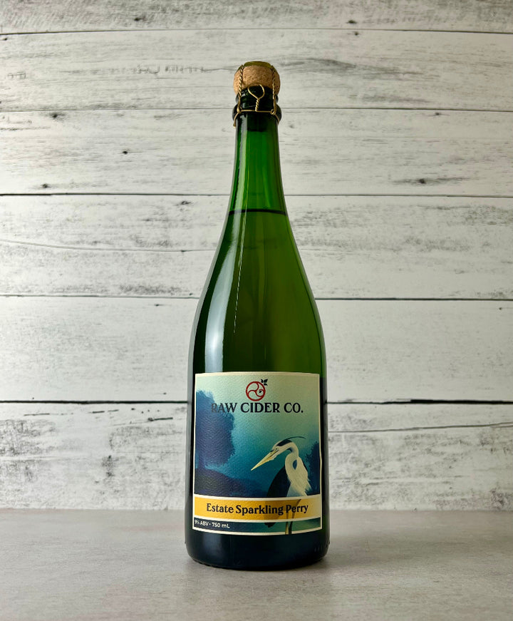 Photo of a 750 mL bottle of Raw Cider Co. Estate Sparkling Perry with cork and cage