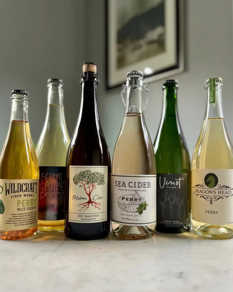 5 bottles of perry - Wildcraft Cider Works Wild Seeded Perry, Barmann Cellars Feral Grape Perry, Madrone Cider 2021 Island Perry, Sea Cider Perry, Jerome Forget Vinot Poire, and Dragon's Head Perry