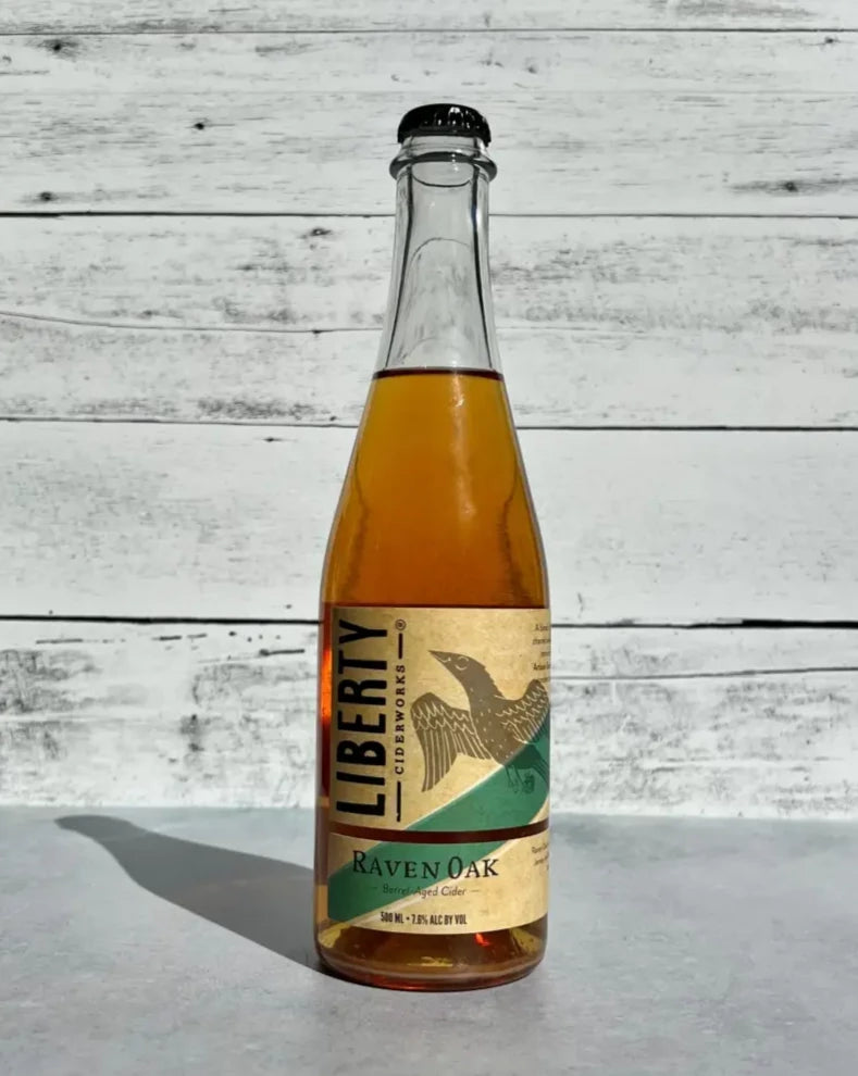 500 mL clear glass bottle of Liberty Ciderworks Raven Oak Barrel Aged Cider