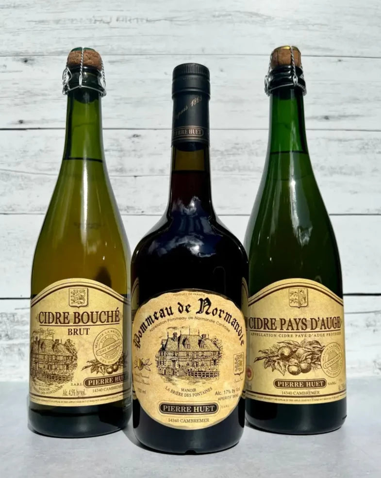 Two bottles of Pierre Huet Cidre cider and one bottle of Pommeau de Normandy