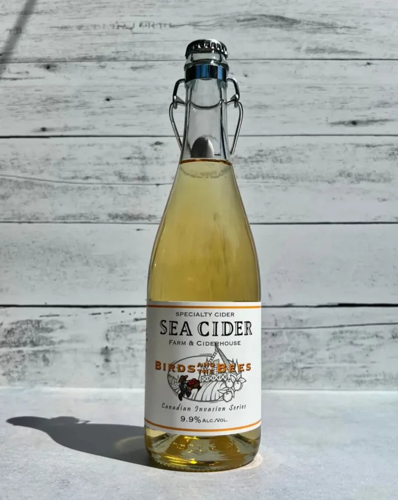 750 mL clear glass bottle of Sea Cider Farm and Ciderhouse  Birds and the Bees Canadian Invasion Series cider with flip top