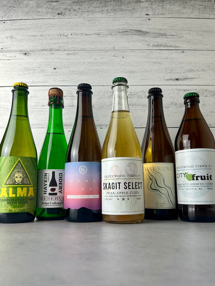 6 bottles of cider in 500 mL and 375 mL bottles: Alma Cider, Haykin Cidery, Peak Light, Greenwood Cider, Madrone Cider, and Greenwood Cider City Fruit cider